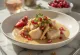 Сациви с индейкой, украшенное ореховым соусом и кинзой